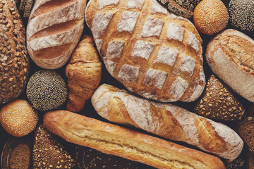 Bread background, top view of white, black and rye loaves