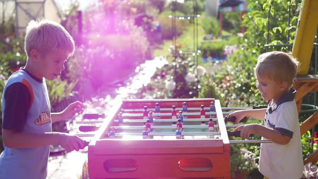 children playing table football outdoors.Fun outdoors