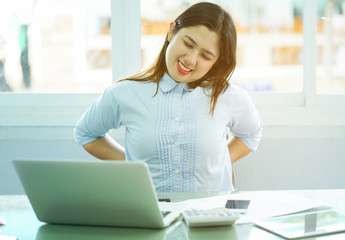 close up employee woman stretching her back after hard working,office syndrome unhealthy lifestyle concept