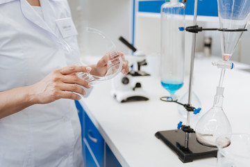 Protective glasses being held by a medical researcher