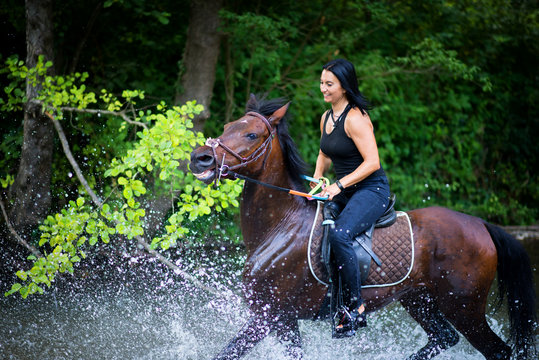 Female,riding her horse on the river