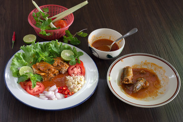 Spicy fish Canned Sardines Salad and ingredient cooking on dark background Thai food /  select focus and flat lay Style.