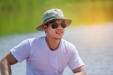 Fishing man with his boat on the river.