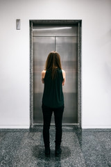 Workspace: Anonymous Woman Waits For Elevator