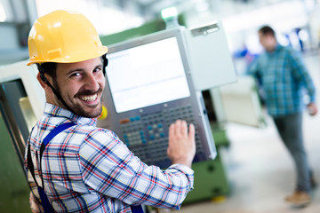 modern industrial machine operator working in factory