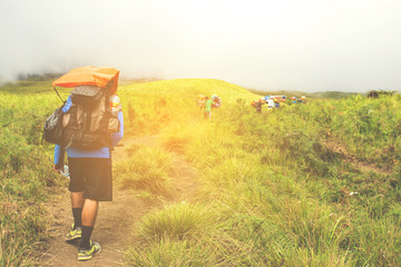 Asian traveling backpacker in volcano mountain Rinjani of Indonesia.