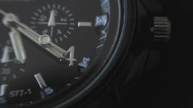 Mens Watch made metal with sapphire glass. Macro video. Time is running out. Close-up of watch with metal  arrows