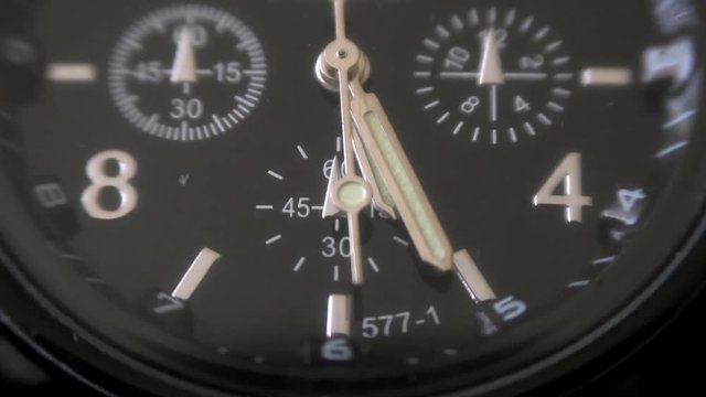 Mens Watch made metal with sapphire glass. Macro video. Time is running out. Close-up of watch with metal  arrows