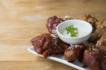 Famous dish Korean fried chickens on the wooden table serves with radish preserved.
