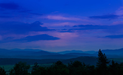 Naklejka premium Photo depicting beautiful a foggy mystic mountains. Fog clouds at the pine tree mystical woods, morning. Europe, Bulgaria, mysterious Balkan landscape.