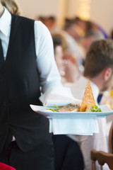 Waitress serving dinner at a feast