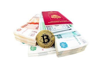 Bitcoin coin and stacks of russian rubles isolated on white background