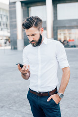 young businessman bearded outdoor using smartphone - remote working, technology, communication concept