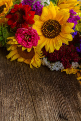 Bright bouquet with fresh fall flowers on wooden table background