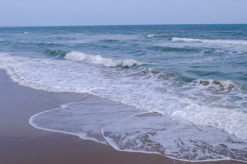 sea with crashing waves at Mae Ramphueng beach in Rayong Thailand