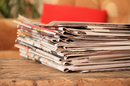 Newspapers on wooden table