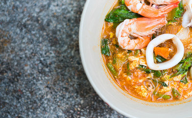 Close up Sukiyaki (Thai Suki) in broth Mixed sea food with vermicelli and vegetables. Copy space for design element.