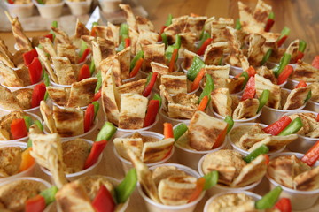 Small Appetizer hors d'oevres in tiny cups with peta bread, peppers, vegetables, general party food
