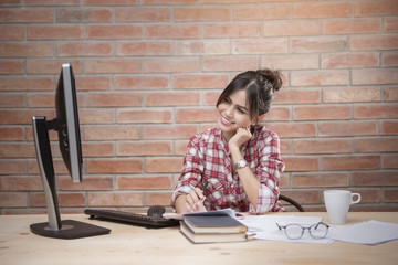 Beautiful woman is working in home office