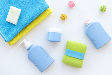 Bathroom set. Towels, bottles with soap and shampoo on white backgrond top view