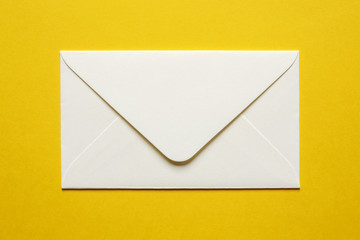 cream envelope on yellow background