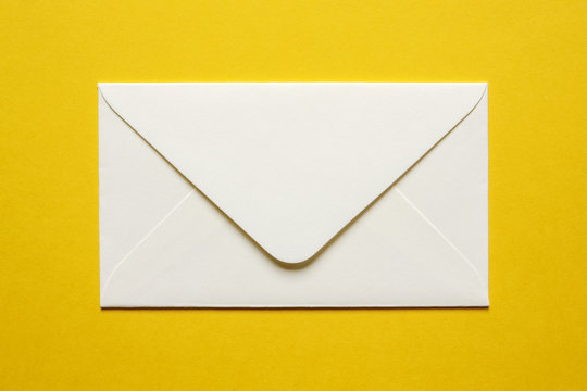 cream envelope on yellow background