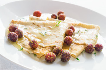 dessert crepes with garden berries and herbs