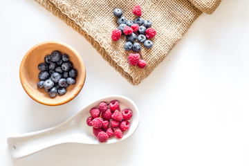 Making summer preserve. Raspberry, blueberry on white background top view copyspace