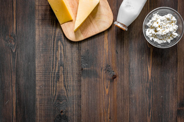 Non GMO, prservatives-free organic food. Milk, cottage, cheese on dark wooden background top view copyspace