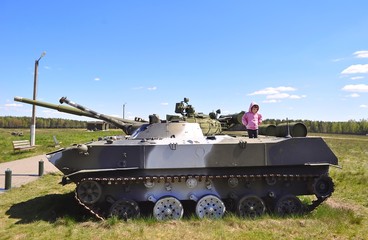 Little girl on army tank.