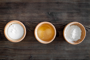 Put the dough. Flour, salt, oil on dark wooden table background top view copyspace