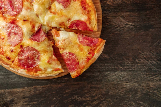 Pepperoni pizza with slice cut off and place for text