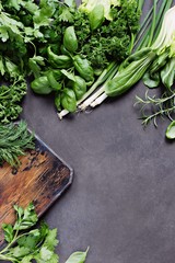 Seasonal green vegetables and herbs. Vegetarian,clean eating and super food concept ingredients. Dinner table with herbs and vegetables variety