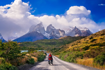 Female cyclist in front of Cuernos del Paine
