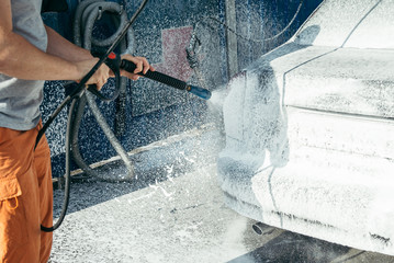 car washing by hand using a foam preparation for polishing,cars in a carwash