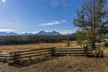 Log Fence Before Pine Forest, Sawtooth Mountains, and Blue Sky