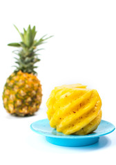 Fototapeta na wymiar Peeled and sliced pineapple on a plate