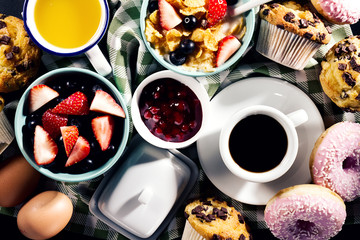 Tasty fresh breakfast food ingredients on black dark background. Ready to cook. Home Healthy Food Cooking Concept.