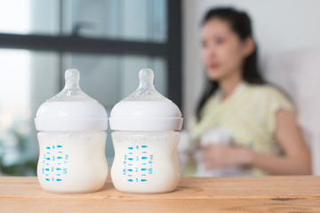 Baby bottle with breast milk for breastfeeding.