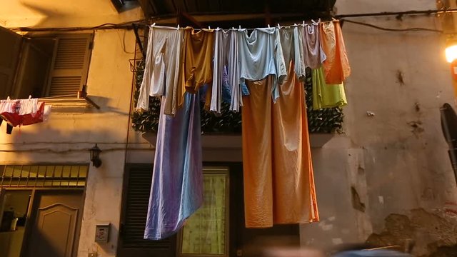 Poor criminal district of Naples, laundry drying on balcony of shabby old house