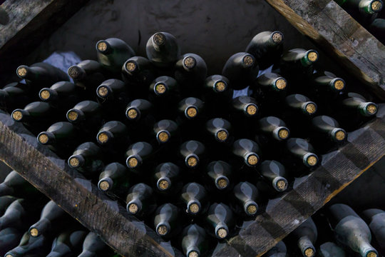 Stacked of old bottles in the cellar