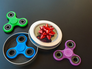 Popular colourful fidget spinner toy in a gift box on a black background