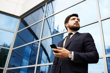 Businessman with smartphone in hand