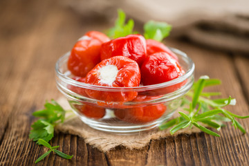 Red Pepper (stuffed with cheese) on wooden background (selective focus)