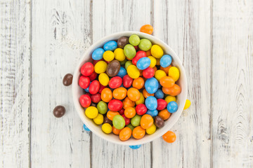 Cocolate coated Peanuts on wooden background (selective focus)