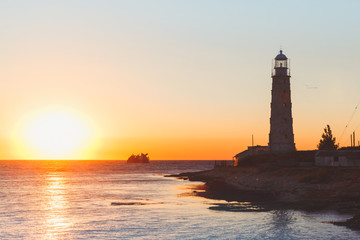 lighthouse at sunset in the twilight in clear weather