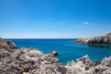 Beach off the coast of the island of Rhodes in Greece. Seaside landscape. Rocky coast and sea.