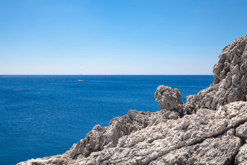 Beach off the coast of the island of Rhodes in Greece. Seaside landscape. Rocky coast and sea.