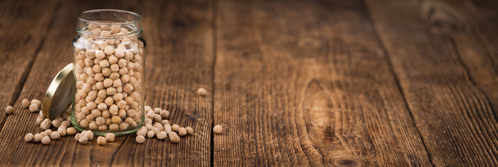 Dried Chickpeas on wooden background; selective focus