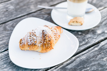 coffee cup latte  and fresh baked croissants on wooden background with copy space